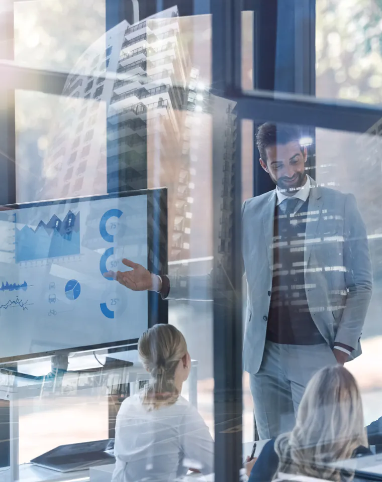 Where Our SAP Consulting Actually Helps: business presentation of analytics charts in a glass office