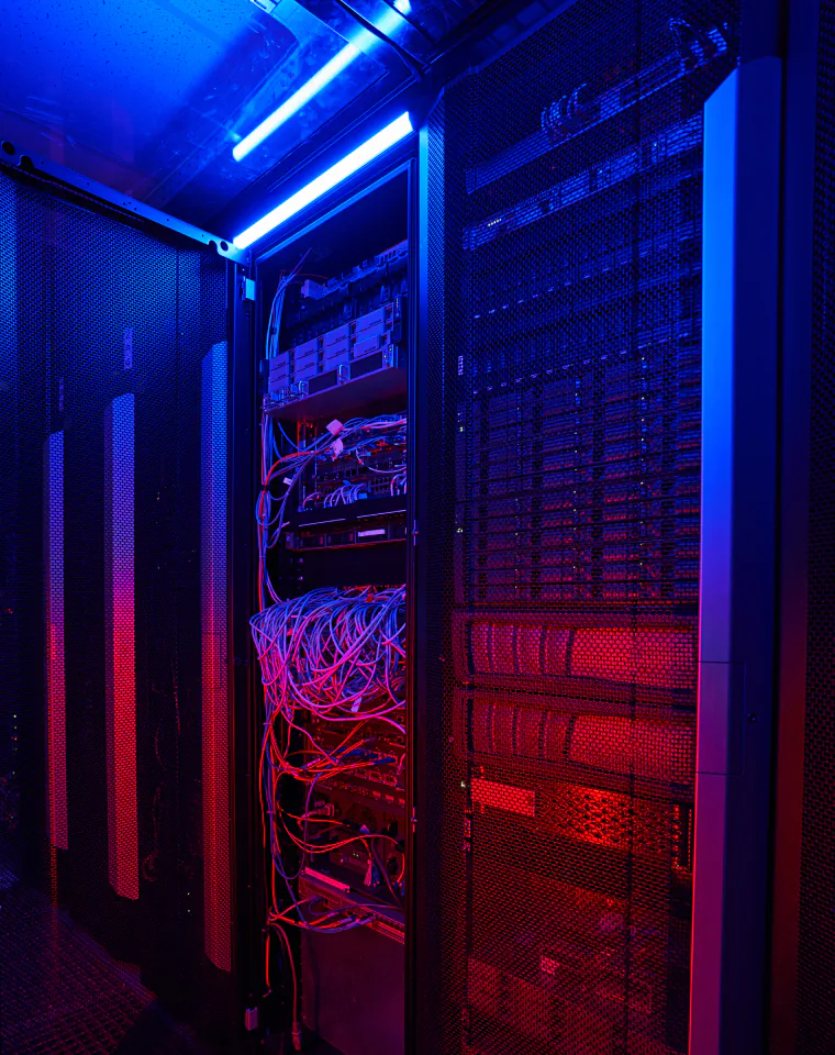 SAP Support & Continuous Improvement: server rack with red and blue cabling in a data center