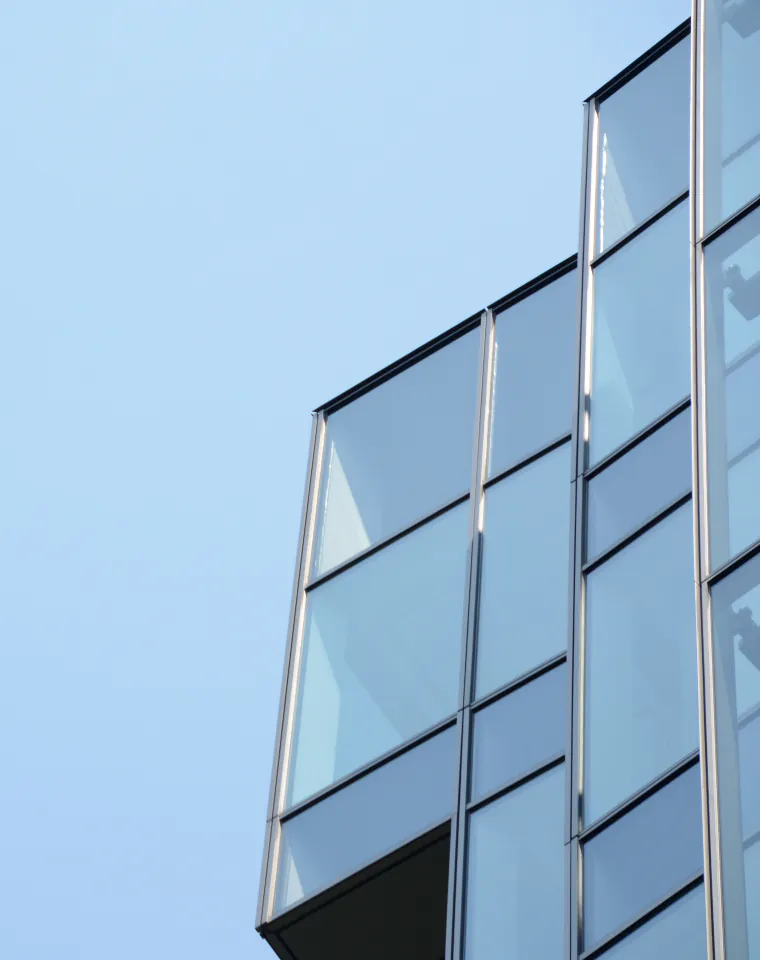 Education: modern glass office building against a blue sky