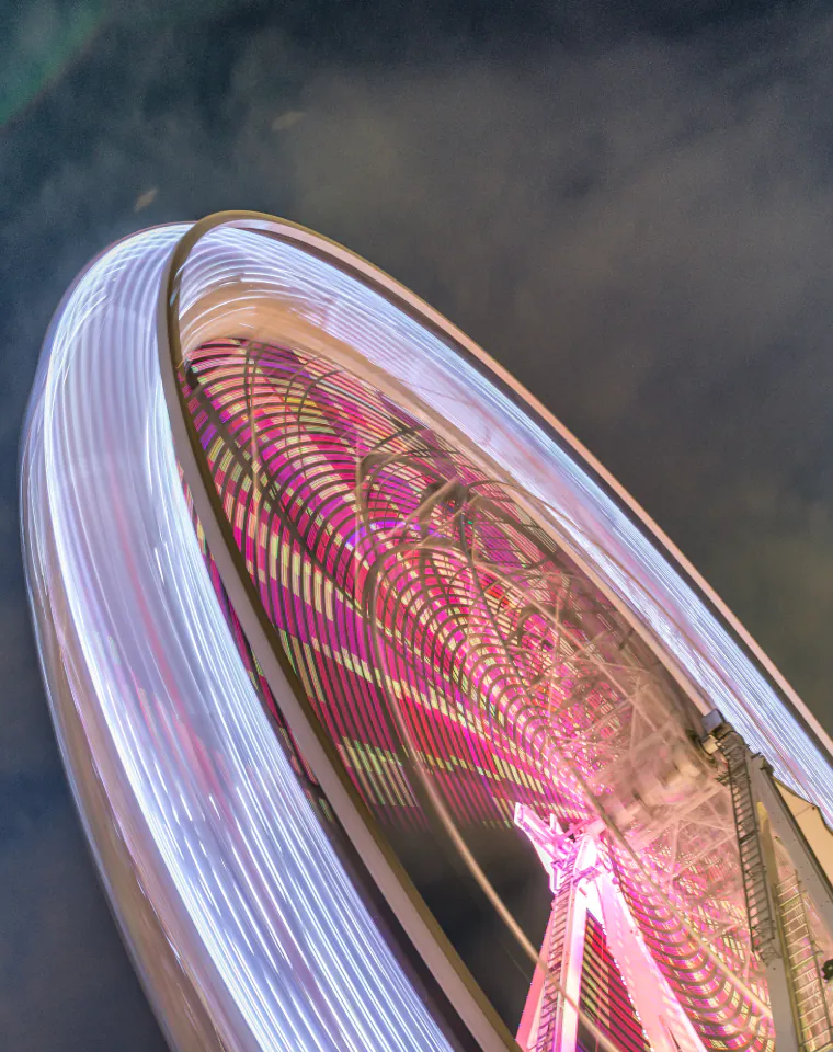 Turn Customer Data Into a Strategic Advantage: illuminated Ferris wheel in motion at dusk