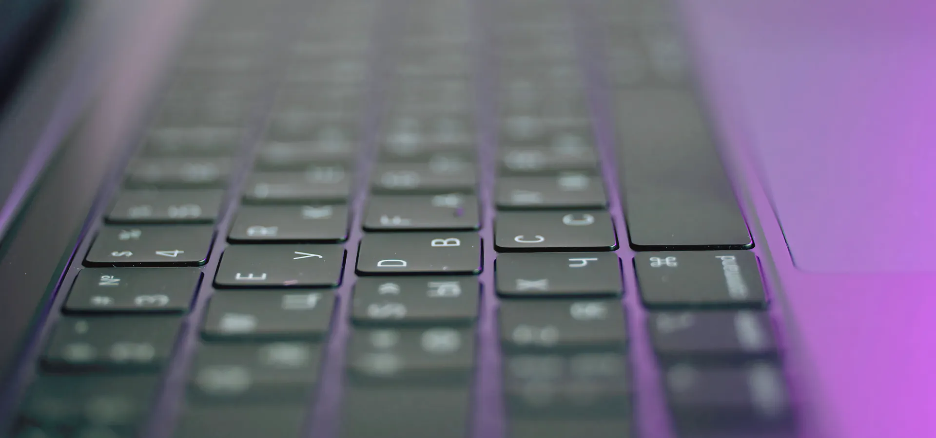 Top C | C++ | C plus plus Consulting company Top C | C++ | C plus plus Consulting company: close-up of a laptop keyboard in purple light