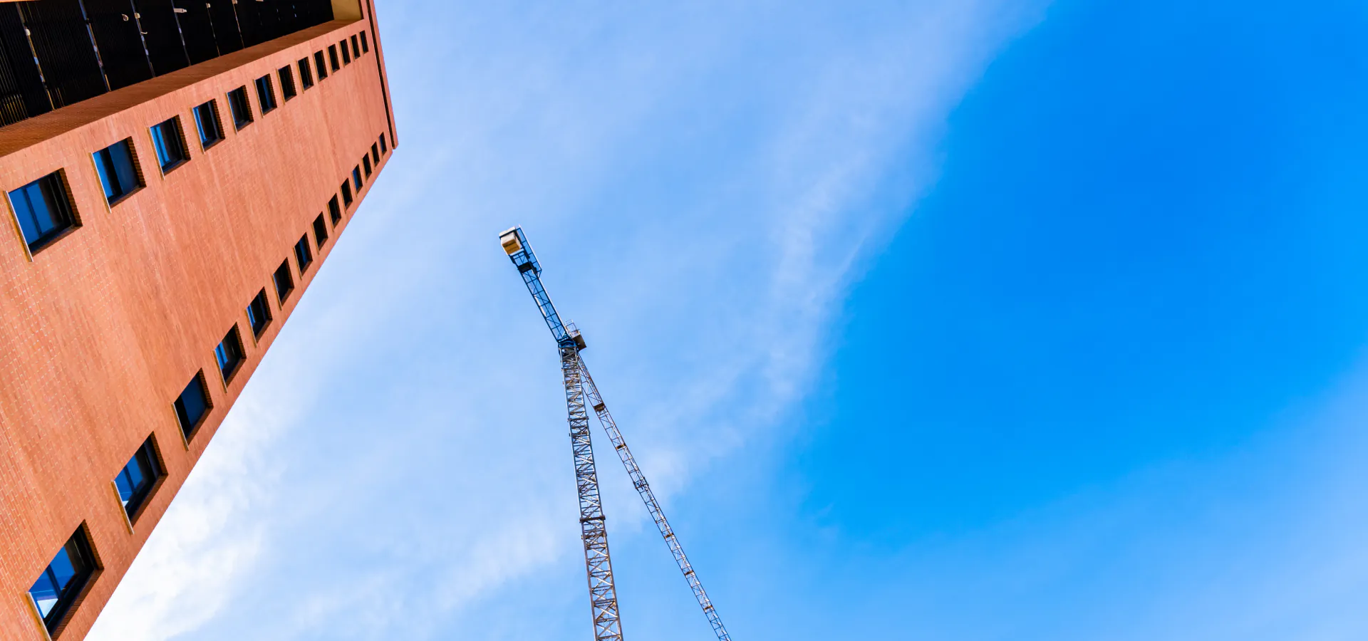 Top Kepware KEPServerEX Communications Automation Consulting company Top Kepware KEPServerEX Communications Automation Consulting company: brick building and construction crane against the sky