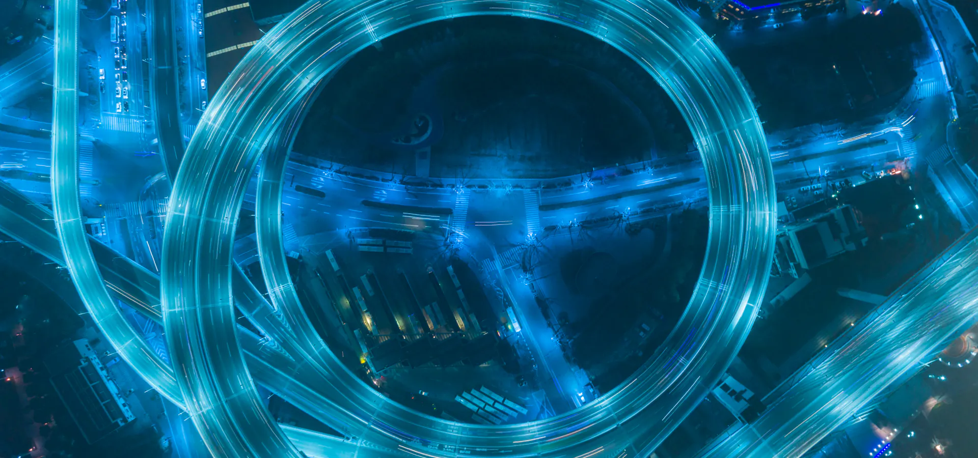 IT Consulting Firm | IT Services & Advisory Services IT Consulting Firm | IT Services & Advisory Services: aerial night view of a glowing circular highway interchange